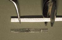 Measure the length of the periodontal splint with the dead soft tinfoil included in the Ribbond kit. Cut the fibers to the corresponding length.