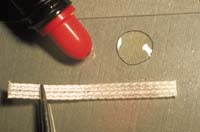 Wet the Ribbond with Ribbond Wetting Resin or an unfilled adhesive bonding resin that does not contain solvents or dentin primers.